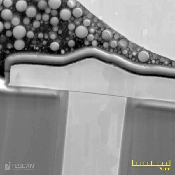 Magnified image of a Cu TSV showing the solder bump, passivation layer, mold compound and liner oxide layer