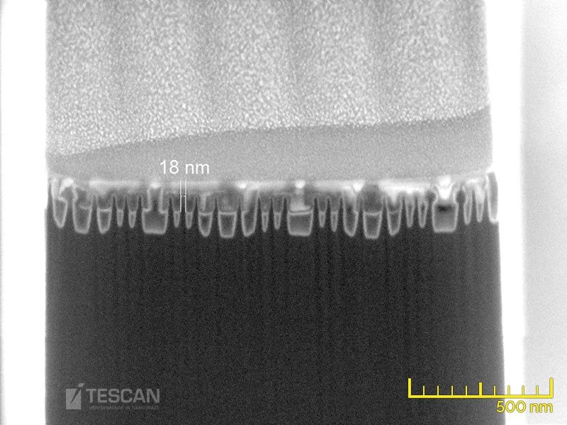 A 14 nm technology node Intel processor. A side-view (“Fin-cut”) of a lamella during thinning, the final lamella was prepared just in the middle of a single fin (thickness less than 20 nm) A 14 nm technology node Intel processor. A side-view (“Fin-cut”) of a lamella during thinning, the final lamella was prepared just in the middle of a single fin (thickness less than 20 nm)